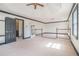 View of the main bedroom featuring a tray ceiling, carpet, staircase, and entryway at 1751 Bergen Ct, Lawrenceville, GA 30043