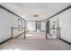 Large main bedroom boasts a tray ceiling and carpet; staircase and doorway visible at 1751 Bergen Ct, Lawrenceville, GA 30043