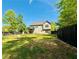 Large backyard featuring a well-maintained lawn, privacy fence, and a home with a second story balcony at 41 Jessica Ln, Dallas, GA 30157