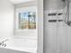 Relaxing bathroom offers a soaking tub with gold fixtures and a glass door shower at 41 Jessica Ln, Dallas, GA 30157