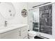 A bathroom with black marble shower tile, a sliding glass door, and a vanity at 41 Jessica Ln, Dallas, GA 30157