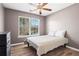 Cozy bedroom featuring neutral walls, hardwood floors, and a large window view at 41 Jessica Ln, Dallas, GA 30157