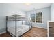Bedroom showcases a bunk bed, hardwood floors, a window, and a dresser at 41 Jessica Ln, Dallas, GA 30157