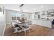 Bright dining area with a farmhouse-style table, modern lighting, and seamless transition to the kitchen at 41 Jessica Ln, Dallas, GA 30157