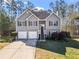 Charming two-story home featuring gray siding, a two-car garage, and a well-maintained front yard at 41 Jessica Ln, Dallas, GA 30157
