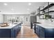 Bright kitchen featuring a large island with sink, stainless steel appliances, and industrial-style shelving at 41 Jessica Ln, Dallas, GA 30157
