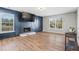Stylish living room with hardwood floors, blue accent wall, fireplace, and large windows for natural light at 41 Jessica Ln, Dallas, GA 30157