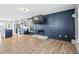 Open-concept living area featuring hardwood floors, a fireplace, and seamless flow to the modern kitchen at 41 Jessica Ln, Dallas, GA 30157