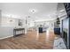 Spacious open-concept living area with hardwood floors, kitchen island, dining area, and stylish lighting fixtures at 41 Jessica Ln, Dallas, GA 30157