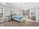 Bright main bedroom boasts a tray ceiling, a light fixture, and hardwood floors at 41 Jessica Ln, Dallas, GA 30157