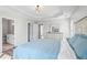 A main bedroom featuring a bed with a blue comforter, an ensuite bath, and modern lighting at 41 Jessica Ln, Dallas, GA 30157