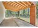 Spacious covered patio with wood columns and beams overlooking the backyard at 4201 Regal Ridge Rd, Austell, GA 30106