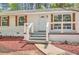 Inviting front porch with updated railings and landscaping, leading to a freshly painted entry door at 4201 Regal Ridge Rd, Austell, GA 30106