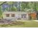 Charming renovated one-story home with white brick, nice landscaping, and covered parking at 4201 Regal Ridge Rd, Austell, GA 30106