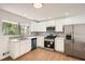 Renovated kitchen with white cabinets, stainless steel appliances, and modern backsplash at 4201 Regal Ridge Rd, Austell, GA 30106