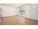 Bright living room featuring sleek floors, a large window, and updated lighting at 4201 Regal Ridge Rd, Austell, GA 30106