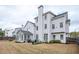 Well-maintained backyard features a spacious lawn, mature trees, patio area, and fenced perimeter at 524 Tackett Farms Rd, Smyrna, GA 30082