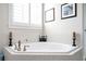 Serene bathroom showcasing a corner tub with tiled surround and modern fixtures at 524 Tackett Farms Rd, Smyrna, GA 30082