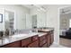 Well-lit bathroom with dual vanities, granite countertops, and dark wood cabinets, offering ample storage and functionality at 524 Tackett Farms Rd, Smyrna, GA 30082