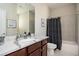 Classic bathroom featuring granite countertop and tub shower with a patterned curtain at 524 Tackett Farms Rd, Smyrna, GA 30082