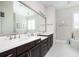 Bright bathroom with double sinks, granite countertops, and a large mirror, creating a spa-like atmosphere at 524 Tackett Farms Rd, Smyrna, GA 30082