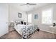 Comfortable bedroom featuring a decorative iron bed frame, ceiling fan and bright natural light from shuttered windows at 524 Tackett Farms Rd, Smyrna, GA 30082