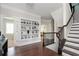 Bright foyer features hardwood floors, staircase, and built-in shelving to display Gathering photos and decor at 524 Tackett Farms Rd, Smyrna, GA 30082