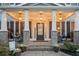 Inviting front porch with brick columns, pendant lights, and comfortable seating at 524 Tackett Farms Rd, Smyrna, GA 30082