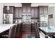 Close-up view of a kitchen featuring dark wood cabinets, a sleek backsplash, stainless steel appliances, and hardwood floors at 524 Tackett Farms Rd, Smyrna, GA 30082
