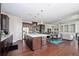 Spacious open-concept kitchen and living area with dark wood cabinets, stainless steel appliances, and hardwood flooring at 524 Tackett Farms Rd, Smyrna, GA 30082