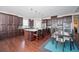 A modern kitchen showcases dark cabinets, a large island with seating, and hardwood floors, creating an elegant and functional space at 524 Tackett Farms Rd, Smyrna, GA 30082