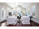 Bright and airy living room with plantation shutters, high ceilings, and an array of windows at 524 Tackett Farms Rd, Smyrna, GA 30082