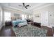 Spacious main bedroom suite with tray ceilings, hardwood floors, and a sitting area, providing a luxurious retreat at 524 Tackett Farms Rd, Smyrna, GA 30082