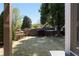 View of the serene, fenced backyard, showcasing lush greenery at 9988 Devonshire St, Douglasville, GA 30135