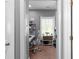 Bedroom featuring a desk with chair, shelves of books, and wall decorations at 9988 Devonshire St, Douglasville, GA 30135