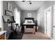 Relaxing bedroom includes a bed with nightstands, decor, and an exercise bike at 9988 Devonshire St, Douglasville, GA 30135