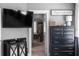 Comfortable bedroom featuring a TV, dark wood furniture, and a view into the ensuite bathroom through an archway at 9988 Devonshire St, Douglasville, GA 30135