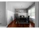 Dining room with hardwood floors, large window, and modern table setting at 9988 Devonshire St, Douglasville, GA 30135