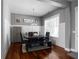 Dining room with hardwood floors, large window, and modern table setting at 9988 Devonshire St, Douglasville, GA 30135