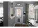Inviting entryway featuring gray walls, decorative accents, and a door with a pet access, enhancing the home's character at 9988 Devonshire St, Douglasville, GA 30135