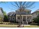 Charming two-story home featuring a welcoming front porch and beautiful landscaping at 9988 Devonshire St, Douglasville, GA 30135