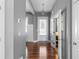 Bright foyer with hardwood floors, gray walls, and a view of the front door at 9988 Devonshire St, Douglasville, GA 30135