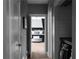 Hallway view showcases a bedroom with neutral decor, a laundry area, and a glimpse of additional living space at 9988 Devonshire St, Douglasville, GA 30135
