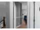 Hallway featuring an open door to a bedroom with nautical decor at 9988 Devonshire St, Douglasville, GA 30135