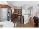 Spacious eat-in kitchen with stainless steel appliances, wood cabinetry, and an adjacent dining area at 9988 Devonshire St, Douglasville, GA 30135