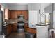 Kitchen with stainless steel appliances, wood cabinets, and black countertops at 9988 Devonshire St, Douglasville, GA 30135