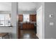 The kitchen has stainless steel appliances, wood cabinets, tile backsplash, and stylish tile flooring at 9988 Devonshire St, Douglasville, GA 30135