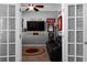 Cozy living room with a dark sofa, ceiling fan, and framed decorations at 9988 Devonshire St, Douglasville, GA 30135