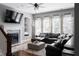 Living room with a fireplace, built-in shelving, and a large sectional sofa at 9988 Devonshire St, Douglasville, GA 30135