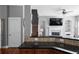 Cozy living room with a fireplace, built-in shelving, and a view of the staircase at 9988 Devonshire St, Douglasville, GA 30135